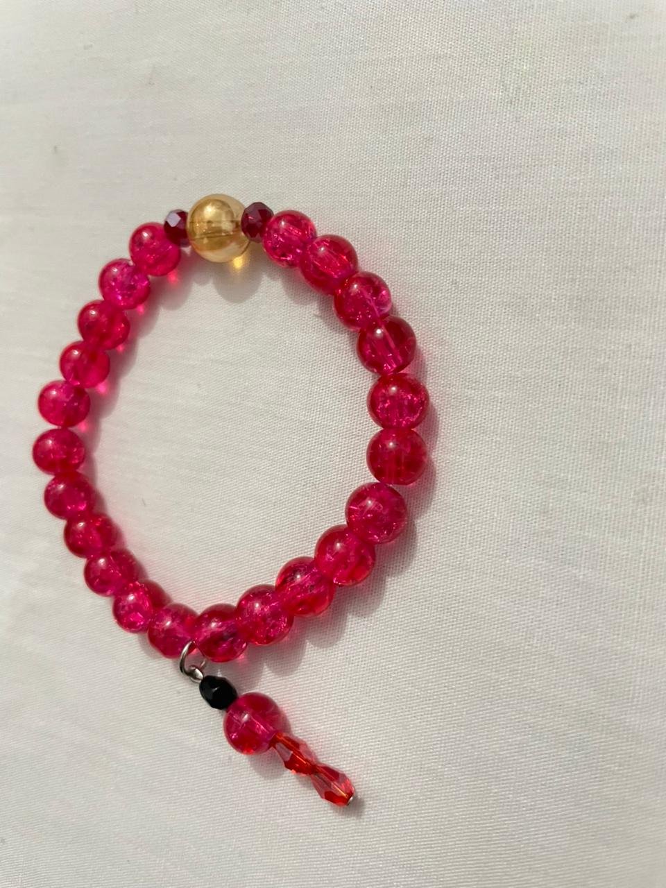 Magenta gold beaded bracelet.